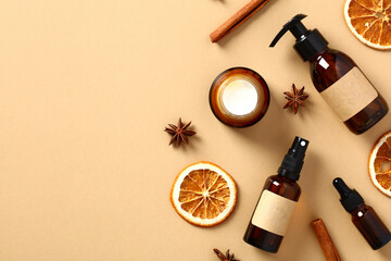Set of natural fall cosmetics with dried orange slices, anise stars, cinnamon sticks on beige...