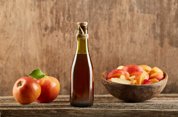 Apple vinegar with apple fruit on old wooden background. Fermented product