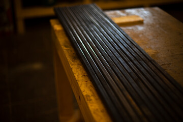 Fototapeta na wymiar Steel profile lies in row. Metal production. Item in garage.