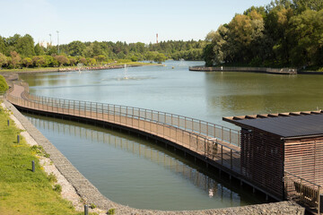 Embankment on lake. View of park. City Pond.