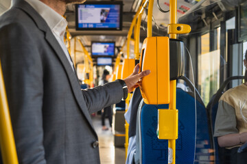 Modern bus interior with passengers. Passengers in the city bus in the evening in Krakow. Modern public transport in Europe. Travel and tourism concept. Safe travel.