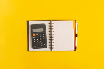 Notebook and calculator on table. Financial development, Banking Account, Statistics
