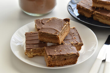 Millionaire's shortbread, caramel shortcake, or millionaire's slice on a white plate.