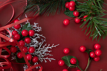 Red Berries and Green Fir as a frame on Red Background