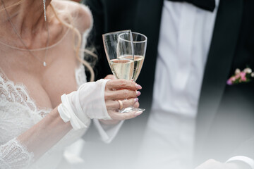 Hands of bride and groom on wedding bouquet. Marriage concept