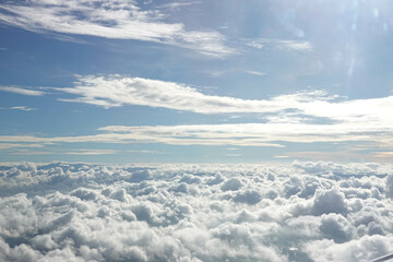 Aerial View from Airplane with City Scape below the Clouds