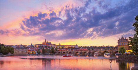 Fototapeta na wymiar City summer landscape at sunset, panorama, banner - view of the Charles Bridge and castle complex Prague Castle in the historical center of Prague, Czech Republic