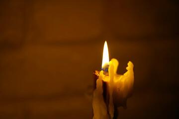 Beautiful candles burning against a dark background. the light source.