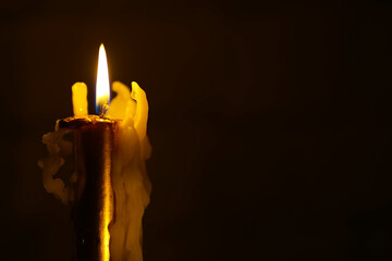 Beautiful candles burning against a dark background. the light source.