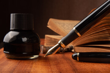 Fountain pen, a beautiful fountain pen on a rustic wooden surface, selective focus.