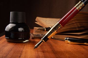 Fountain pen, a beautiful fountain pen on a rustic wooden surface, selective focus.