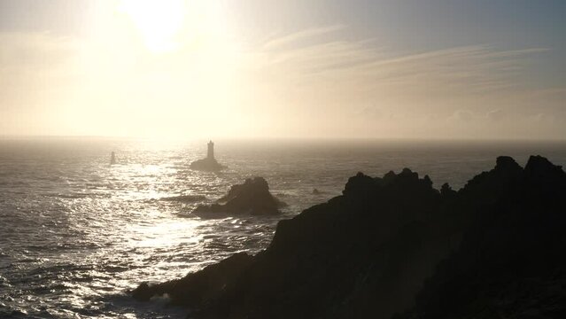 The lighthouse "la Vieille" and the "Pointe du Raz", a famous cape in the west of France during sunset.