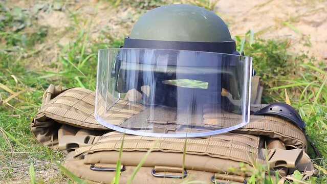 Helmet with plastic glass and body armor close-up