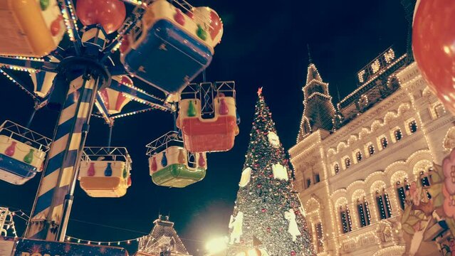 Fairy-tale decorations, festive garlands and a beautiful, colorful carousel against the backdrop of the Christmas tree and glowing with lights building on Red Square create a festive, New Year's mood.