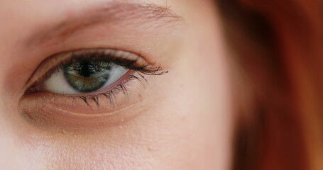 Obraz premium Woman eye squinting. closeup of girl left eye squints and blinking