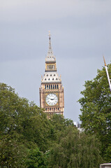 Fototapeta na wymiar The London Clock Tower with the famous Big Ben bell can be seen behind the trees.