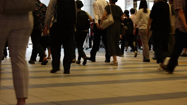Japanese businessmen and women are commuting in the morning rush hour