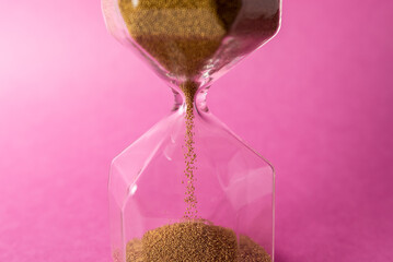 hourglass closeup on red background