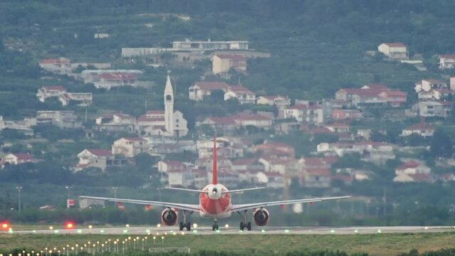 The plane is moving along the runway of the airport. Airplane with tourists and airport life. High quality 4k footage