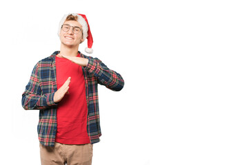Happy young man at Christmas making a time out gesture with his hands