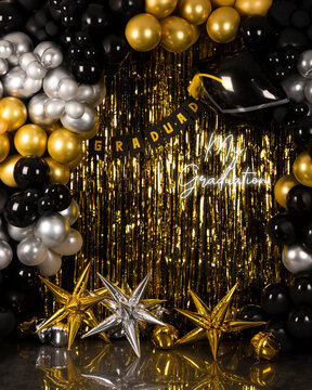 graduation background with gold silver and black balloons