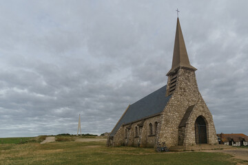 Fototapeta na wymiar Church Notre Dame de la Garde chapel on the hillside at the Alabaster Coast, Etretat village, Normandy, France