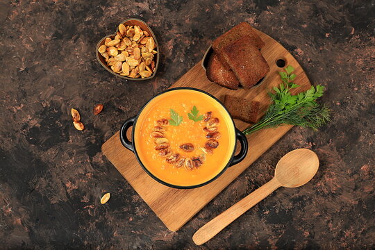 Pumpkin and zucchini cream soup with roasted seeds and toast,traditional autumn vegan food,healthy natural breakfast,advertising for cafe,restaurant,business card