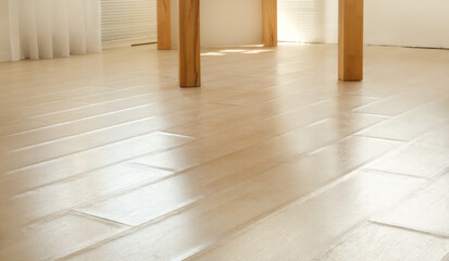 Swollen laminate flooring from flood or water damage, perspective view. Living room with beige...