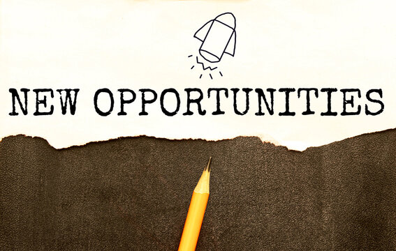 On a bright red background, white crumpled sheets of paper and a sheet of paper with the text New Opportunities - Powered by Adobe