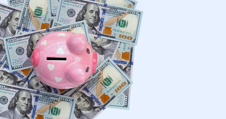 Piggy bank on one hundred dollar banknotes. Financial concept