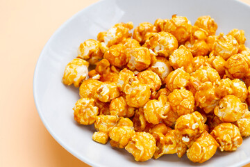Honey caramel popcorn on white background.