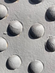 Fototapeta na wymiar A group of round rivet heads on a grey painted metal surface