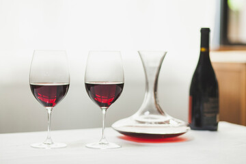Close-up of red wine with decanter and bottle on table