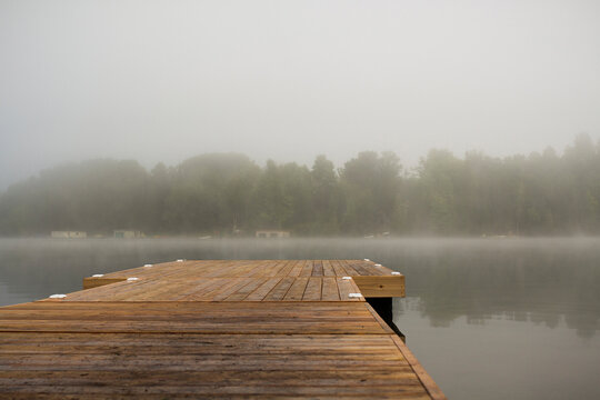 Fototapeta Wooden pier over lake against sky during foggy weather