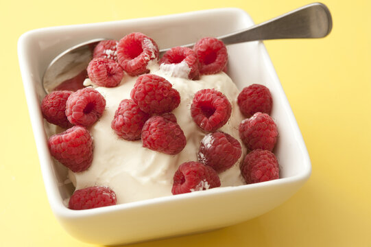 Fresh Raspberries On A Bowl Of Plain Yoghurt