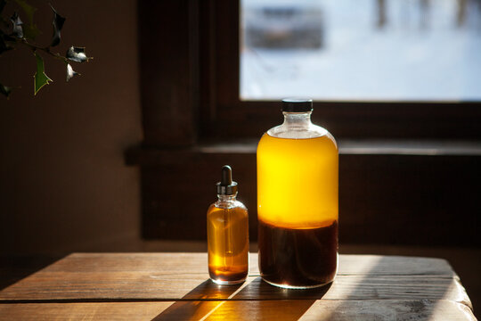 Oil bottles on wooden table at home