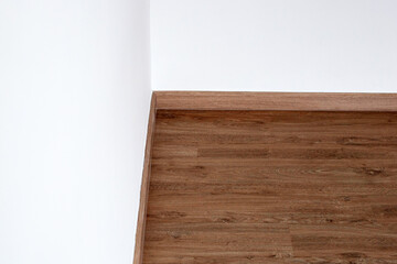 Naklejka na ściany i meble Laminate wood floor with blank white wall