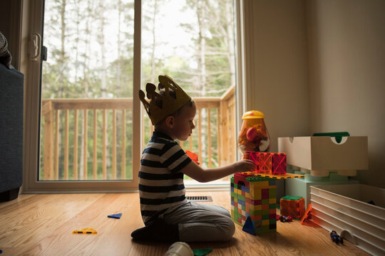 Side view of boy playing with toy blocks at home