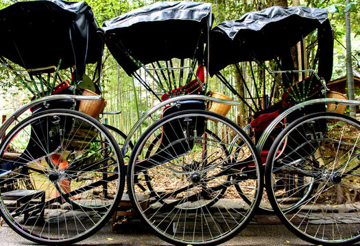 Jinrikisha parked side by side on road