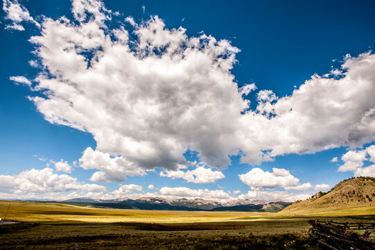 Idyllic view of landscape against cloudy sky