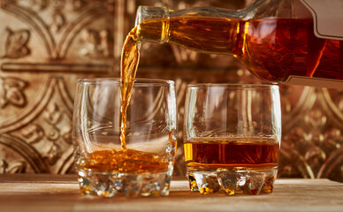 Close-up of whiskey being poured into glass on table