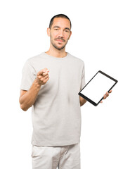 Young man doing gestures using a tablet