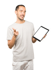 Young man doing gestures using a tablet