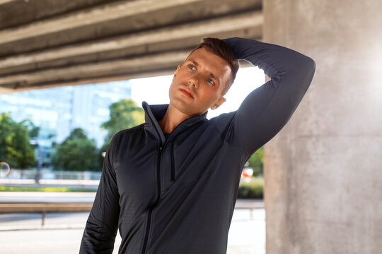 fitness, sport and healthy lifestyle concept - man stretching neck under bridge