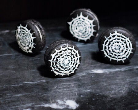 Close-up of macaroons on table in darkroom