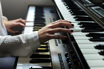 Close-up of pianist practicing piano at home