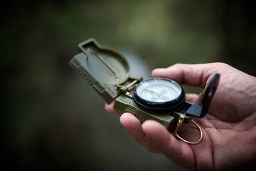 Cropped hand of male hiker holding navigational compass