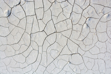 High angle view of cracked muddy field