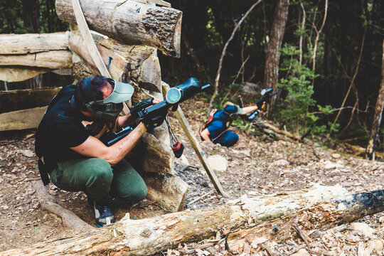High angle view of army soldiers aiming guns in forest