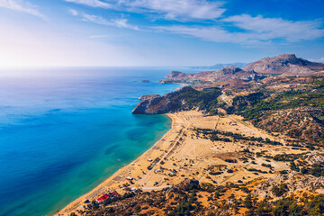 Tsampika beach with golden sand view from above, Rhodes, Greece. Aerial birds eye view of famous beach of Tsampika, Rhodes island, Dodecanese, Greece - obrazy, fototapety, plakaty